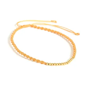 Adjustable friendship bracelet cotton string in twist design and gold plated on sterling silver beads at the center(Orange)